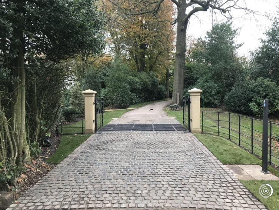Cobblestone driveway with gates